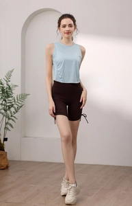 Detail shot of light blue yoga top featuring side ruched design and waist gathering effect