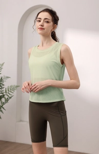 Mint green open back yoga vest with olive high waist gym shorts and side pockets