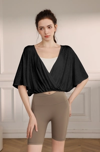 Detail of black jacquard wrap yoga top paired with khaki high-waisted fitness shorts