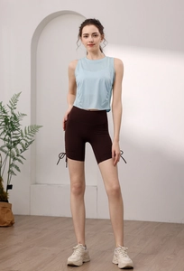 Detail view of high-waist yoga shorts with side drawstring cords in dark brown