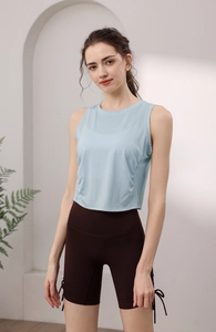 Detail of light blue tencel sports vest with side drawstring brown shorts on a model
