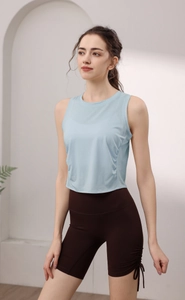 Detail of light blue sleeveless yoga top and brown drawstring high-waist sports shorts