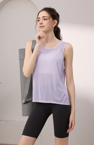 Side view of lavender sleeveless sports tank top paired with high-waist black biker shorts