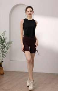Detail of high-waist yoga shorts with side drawstrings and slim fit tencel tank top