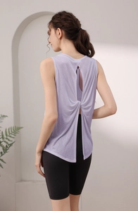Detail of the elegant twisted open back design on a lavender tencel yoga tank top