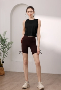 Detail view of high-elastic black yoga top and brown drawstring cycling shorts set