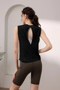 Detail of backless sports tank top with cutout and high-waisted shorts with phone pocket
