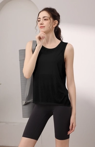 Detail of loose black yoga vest and high-waist biker shorts on a fitness model