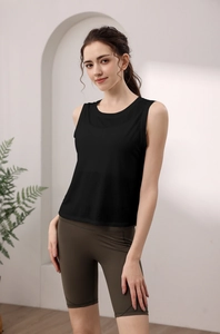 Close-up of a seamless black yoga tank top paired with high-waisted olive green biker shorts
