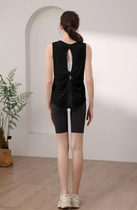 Detail of black backless sports tank top with cutout twist design for fitness yoga