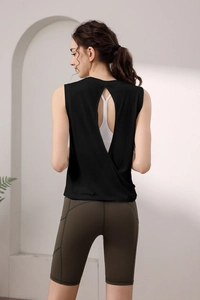 Back view of open back yoga top and olive green biker shorts with side pockets