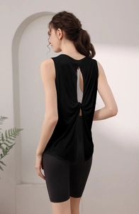 Close-up of black breathable yoga tank top featuring a stylish back hollow twist design