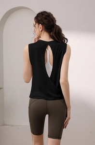 Detail of a backless yoga tank top showing the cut-out design and activewear layering
