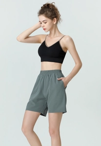 Detail of high-waist summer sports shorts with side pocket and elastic waistband