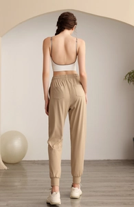 Detail view of khaki jogger pants with elastic high waist and dual back pockets