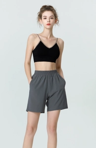 Detail of high-waist grey sports shorts with pockets and black slim fit yoga tank top