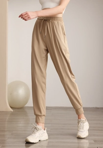 Detail of high waist khaki sports joggers with drawstring waist and ribbed cuffs