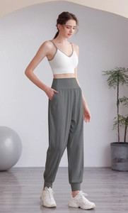 Dettaglio dei pantaloni jogger a vita alta verde oliva con tasche per fitness e yoga