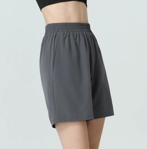 Detail of high waist pleated elastic waistband on dark grey athletic shorts for women