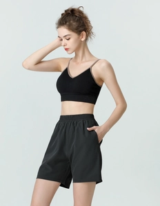 Detail of black sports bra and shorts set with elastic waistband and v-neck line