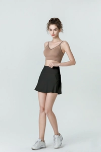Zijaanzicht van zwarte sport-skort met hoge taille en bruine sport-bh met V-hals op model