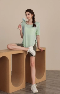 Detail of light green yoga top featuring unique criss-cross cutout neckline design