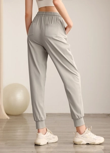 Detail showing high waist elastic band and back square pockets on grey jogger pants