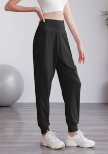 Détail d'un jogging en nylon noir à taille haute avec des poignets élastiques aux chevilles