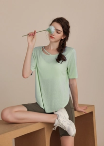 Detail of light green T-shirt with layered crossover neckline and breathable texture
