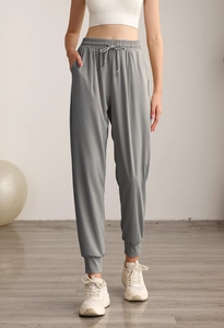 Detail of high waist grey joggers with drawstring waist and ribbed ankle cuffs