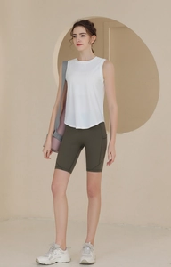 Détail du débardeur de sport en mesh blanc et du short cycliste olive pour le fitness