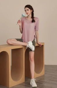 Detail of light pink Tencel yoga top with cross-strap neckline and breathable texture