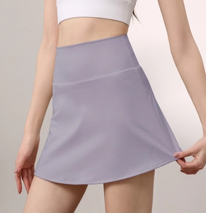 Detail of high waisted lavender tennis skirt showing the elastic A-line shape and smooth fabric