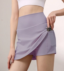 Detail view of high-waisted sports skort with hidden side pocket for mobile phone storage
