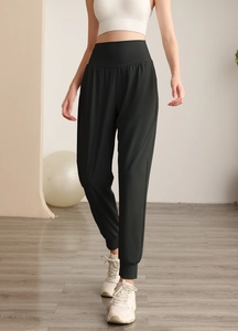 Dettaglio dei pantaloni jogger da yoga neri a vita alta con ampia fascia per addome piatto