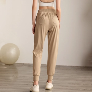 Women's high-waisted khaki loose jogger pants with pockets shown from the back view