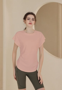 Detail of light pink breathable sports top featuring batwing sleeves and curved hem design