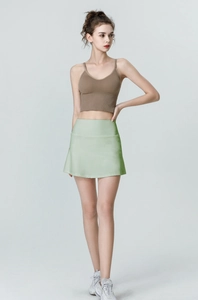 Light green high-waisted tennis skirt with built-in shorts for running and yoga wear