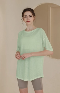 Detail of loose light green tencel workout top paired with grey high waist cycling shorts