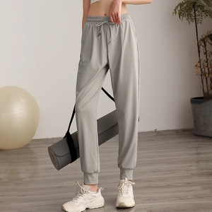 Women high-waisted loose grey joggers with drawstring waist and elastic cuffs for fitness