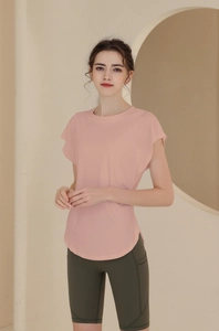 Detail view of pink ruffled short sleeves and high waist olive green yoga shorts