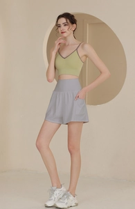 Seitenansicht des lindgrünen Ripp-Tanktops und grauer Sportshorts mit hoher Taille