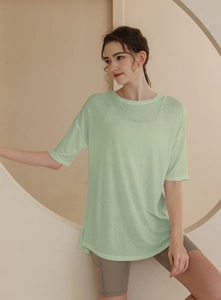 Detail of light green loose-fit T-shirt in breathable tencel fabric for fitness