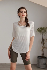 Detail of white yoga t-shirt featuring a stylish hollow-out crisscross neckline design