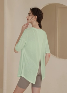Detail of light green sports t-shirt with a stylish vertical back slit design