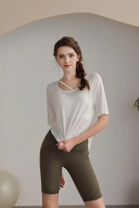 Detail of cross strap neckline on a semi-transparent white tencel yoga top for women