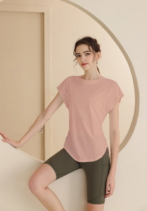 Close-up of light pink short-sleeved sports t-shirt and olive green cycling shorts