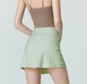 Close-up of high-waisted light green sports skirt with moisture-wicking fabric