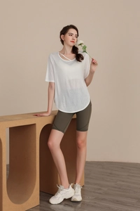 Detail of white tencel yoga t-shirt featuring a cross-hollow neckline and breathable mesh