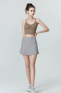 Front full view of women high waisted sports skirt and brown ribbed knit crop tank top